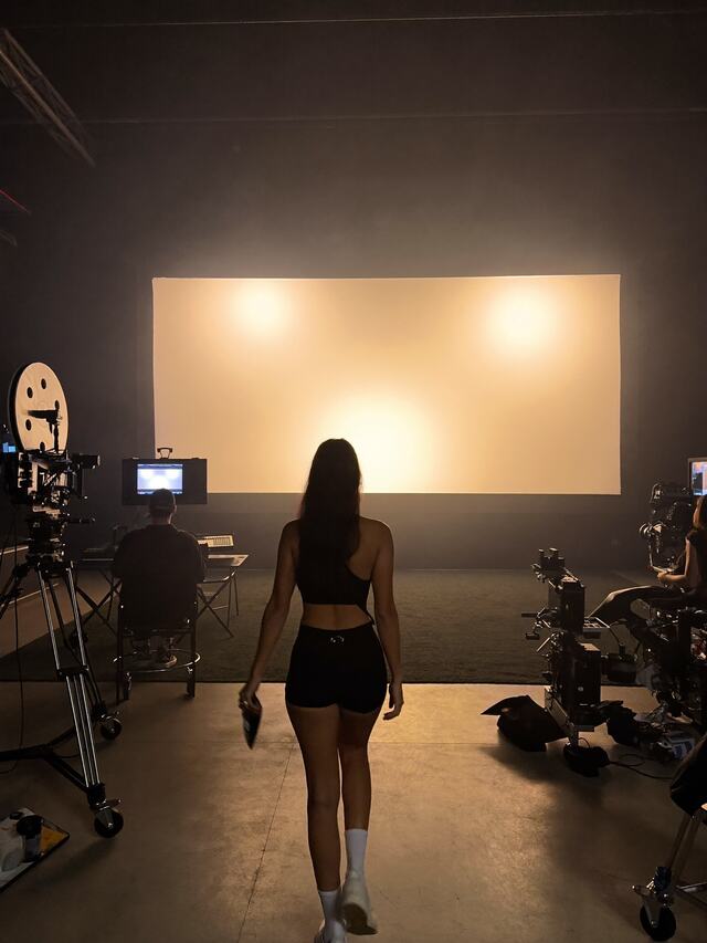 A virtual talent walking onto a film studio set